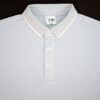 Light gray polo shirt with white collar and buttons on a black background
