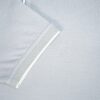 Close-up of a light gray shirt with a mesh panel on a light gray background