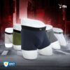 Men's underwear displayed on mannequin legs with a dark urban background