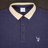 Navy blue polo shirt with beige collar and fils logo on a dark background