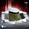 Three pairs of men's underwear in green, black, and gray on a futuristic cityscape background with 'fils' branding.