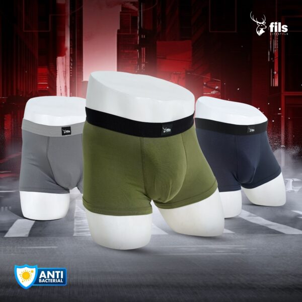 Three pairs of men's underwear in gray, green, and black on a dark background with 'fils' branding.