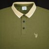 Green polo shirt with beige collar and fils logo on a black background
