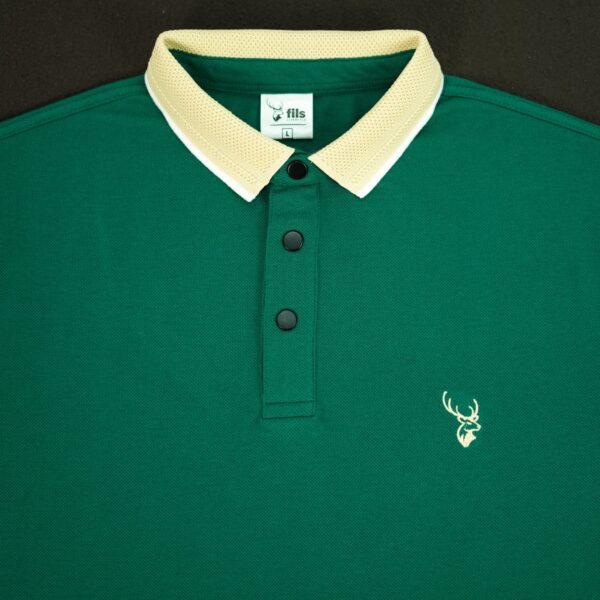 Green polo shirt with a white collar and fil logo on a black background