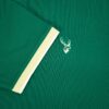 Green polo shirt with a fils logo on a green background